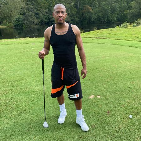 Antwon Tanner playing golf at the charity event.